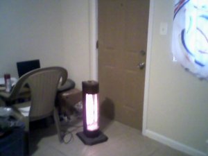 My departing neighbor gave me this quartz heater.  (Notice the home made curtain covering my one and only window?) 